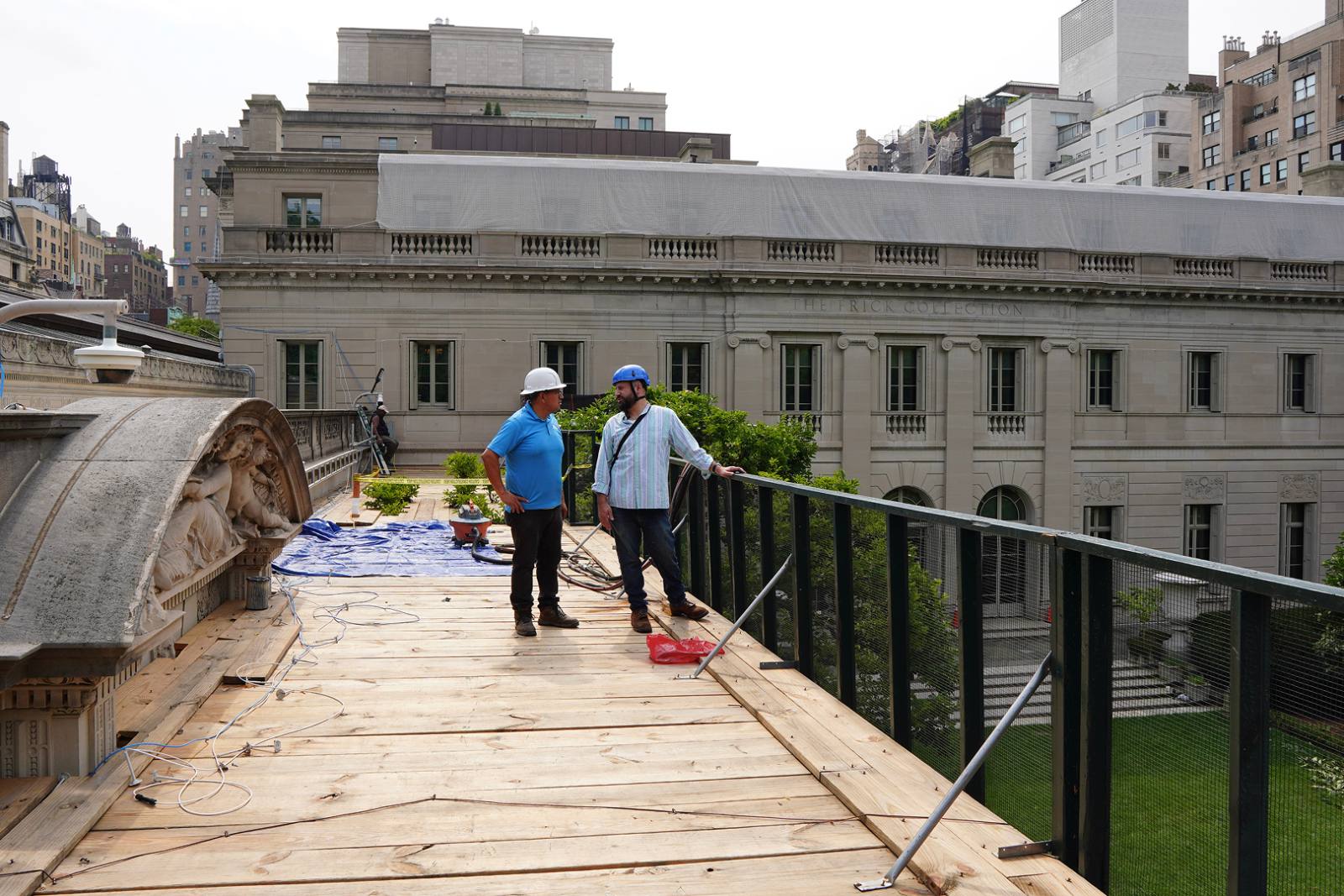 Crew on the roof walkway above the limestone facade at The Frick Collection, Upper East Side, Manhattan
